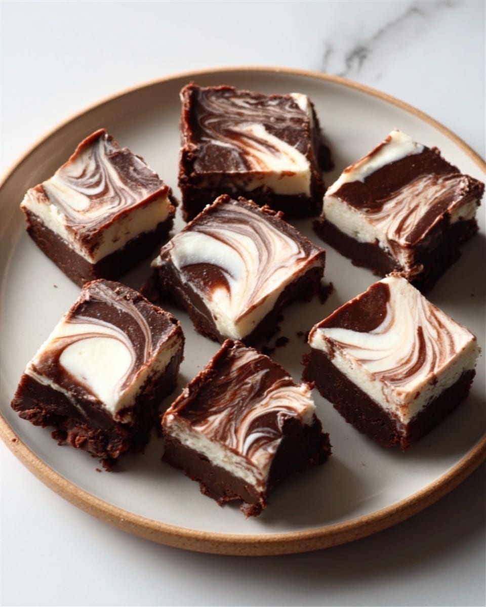 A white plate with six square pieces of chocolate fudge arranged on it, each piece showing two layers with a dark chocolate base and a top layer swirled with white cream in a marbled pattern; the fudge pieces have rough edges and some bites taken from them, revealing the creamy inside, set on a white marbled surface. photo taken with an iphone --ar 4:5 --v 7