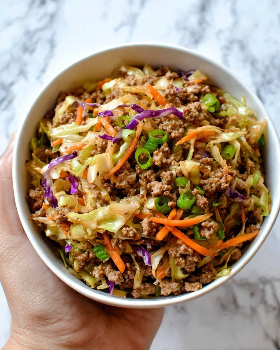 A white bowl filled with a mixed dish shows three main layers: the base is cooked ground meat colored light to medium brown with a crumbly texture, the middle layer is shredded cabbage in shades of light green and purple adding a crispy look, and the top layer consists of thin strips of bright orange carrots and small green onion pieces scattered throughout, all combined together to create a colorful and textured appearance, held gently by a woman's hand against a white marbled background. photo taken with an iphone --ar 4:5 --v 7