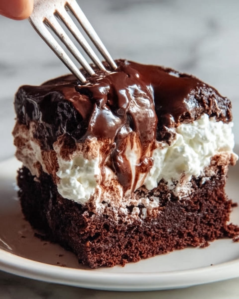 The image shows a close-up of a rich chocolate dessert with three visible layers on a white plate. The bottom layer is a thick, dark brown, moist chocolate cake. Above it, there is a layer of white whipped cream that looks soft and fluffy, peeking out from the sides. The top layer is a shiny, smooth dark chocolate ganache that is dripping slightly over the sides of the dessert, creating a glossy texture. A woman's hand holding a fork is about to take a bite, pressing gently into the layers. The background is a white marbled surface. photo taken with an iphone --ar 4:5 --v 7
