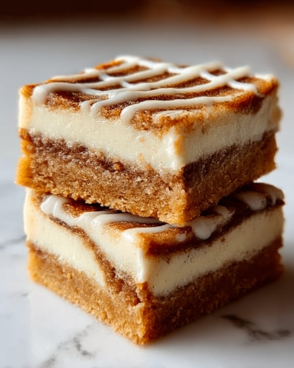 Two square pieces of dessert stacked on a white marbled surface, each showing three clear layers: a golden-brown crust at the bottom, a creamy white middle layer, and a cinnamon-spiced brown swirled top layer with a smooth, shiny glaze. The dessert's texture looks soft and moist, with the top layer having a slightly bumpy cinnamon swirl pattern. The stack glistens under warm light, highlighting the creamy and spiced layers. Photo taken with an iphone --ar 4:5 --v 7